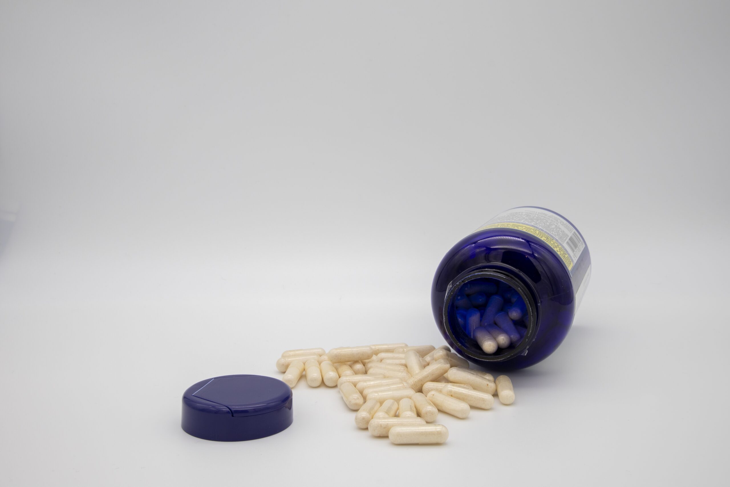 White tablets from a blue pill bottle